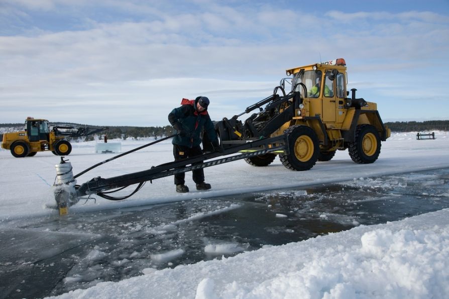 Погрузчик Volvo вырезает лед для отеля Icehotel
